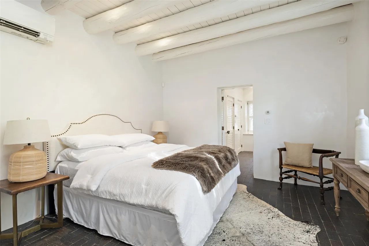 A bedroom with a king size bed and a chair