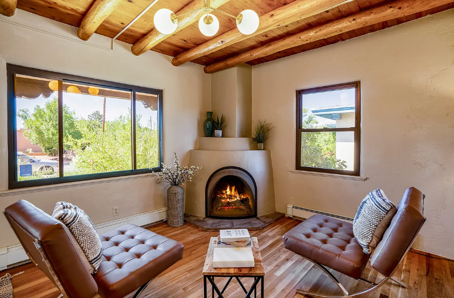 There is a fireplace in the corner of the living room.
