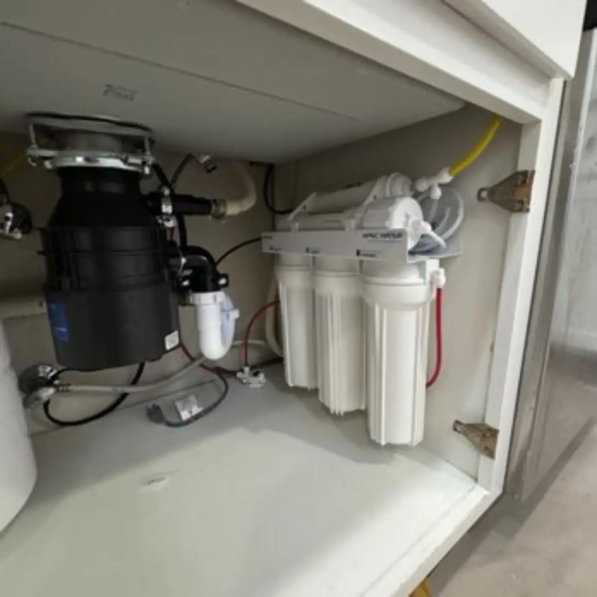 Pipex Plumbing - A kitchen sink with a garbage disposal and a water filter