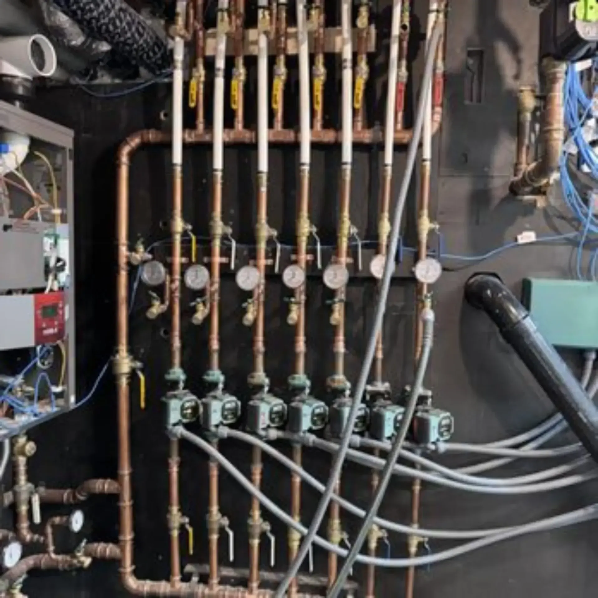 Pipex Plumbing - A bunch of copper pipes and wires on a wall