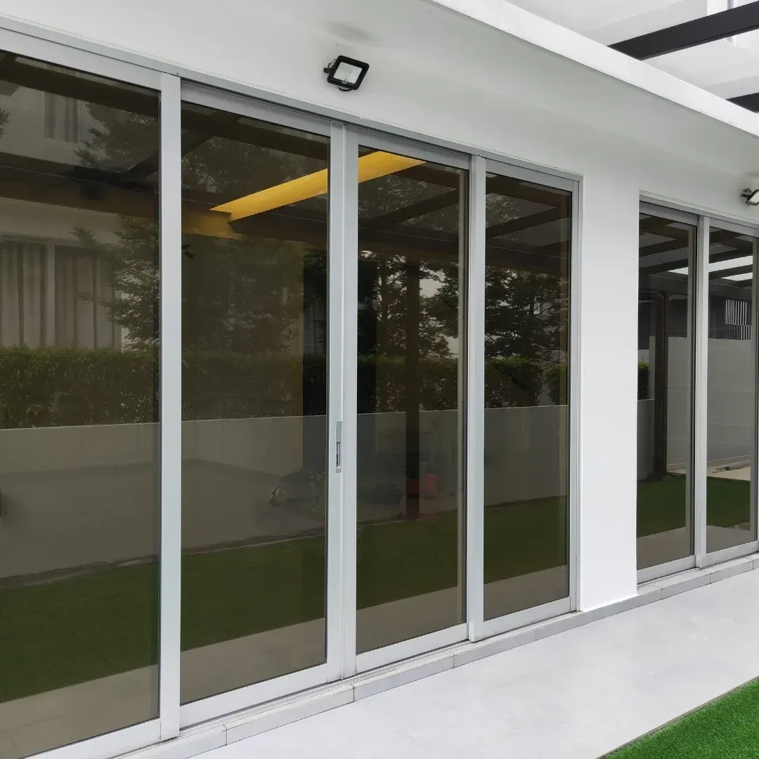 Modern glass sliding doors on a white exterior wall of a building