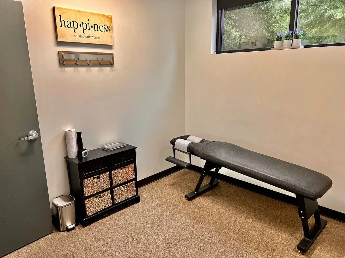 A room with a table and a sign on the wall.