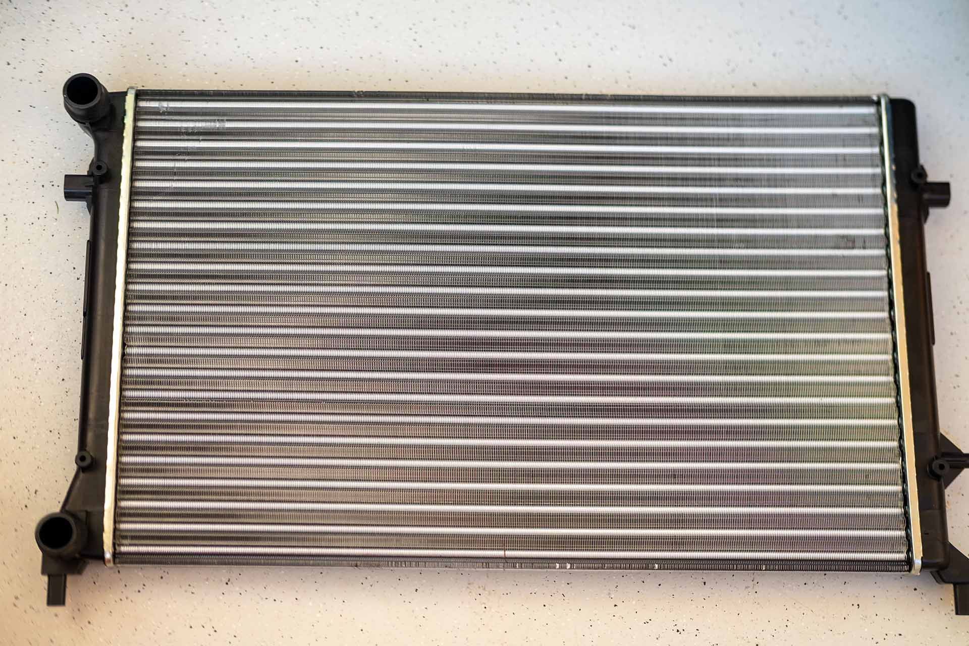 Shiny new car radiator with clean fins and polished finish, ready to install. Shiny new car radiator with clean fins and polished finish, ready to install.
