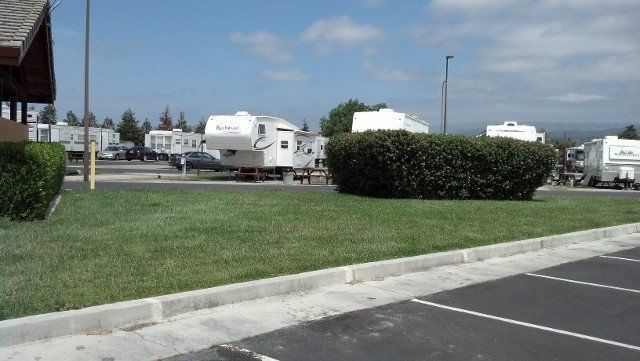 A lot of rv 's are parked in a parking lot