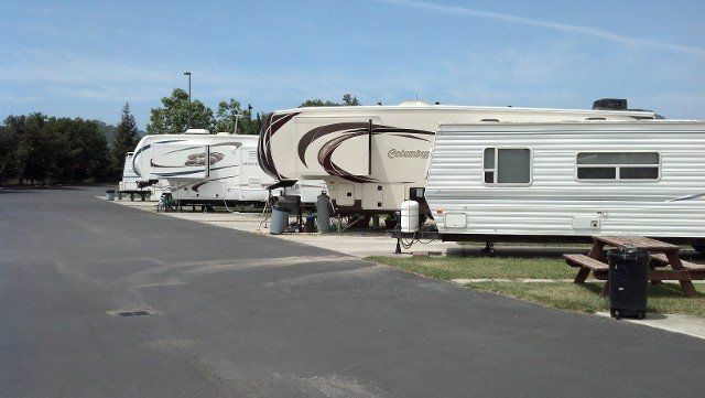 A row of rvs parked on the side of a road.