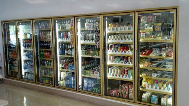 A grocery store refrigerator filled with lots of food and drinks.