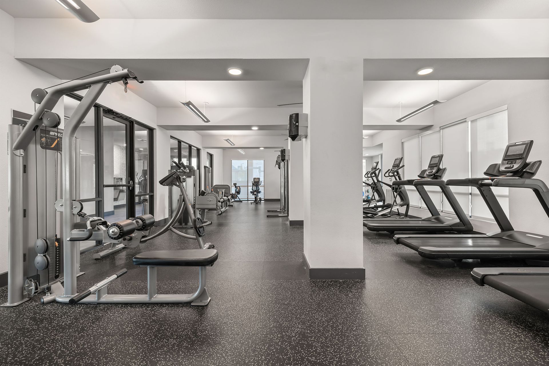 A gym with a lot of treadmills and exercise equipment for active student living at The Heights offers student apartments near SHSU.