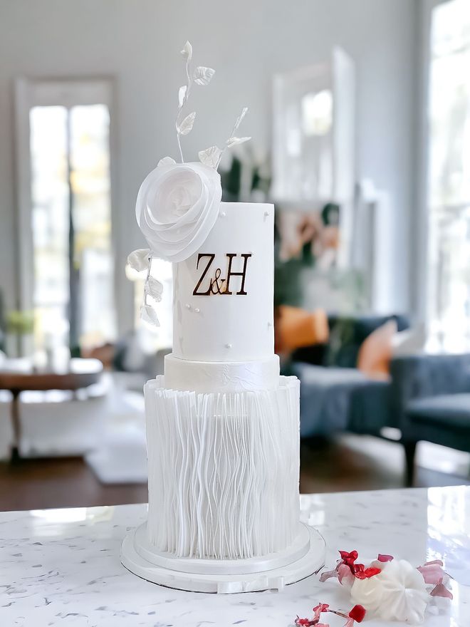 Three-tiered white cake with a floral top, 