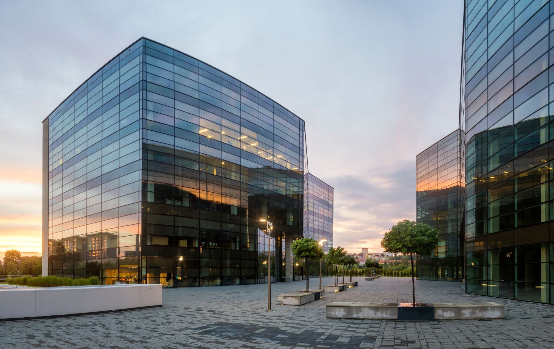 A group of tall buildings with trees in front of them.