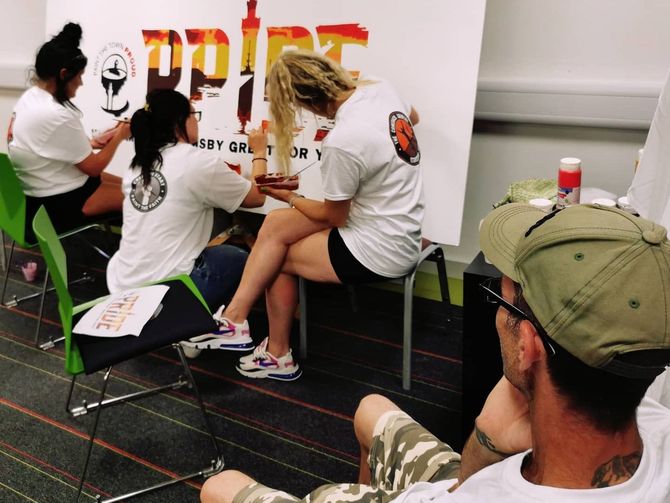 A group of people working on a mural