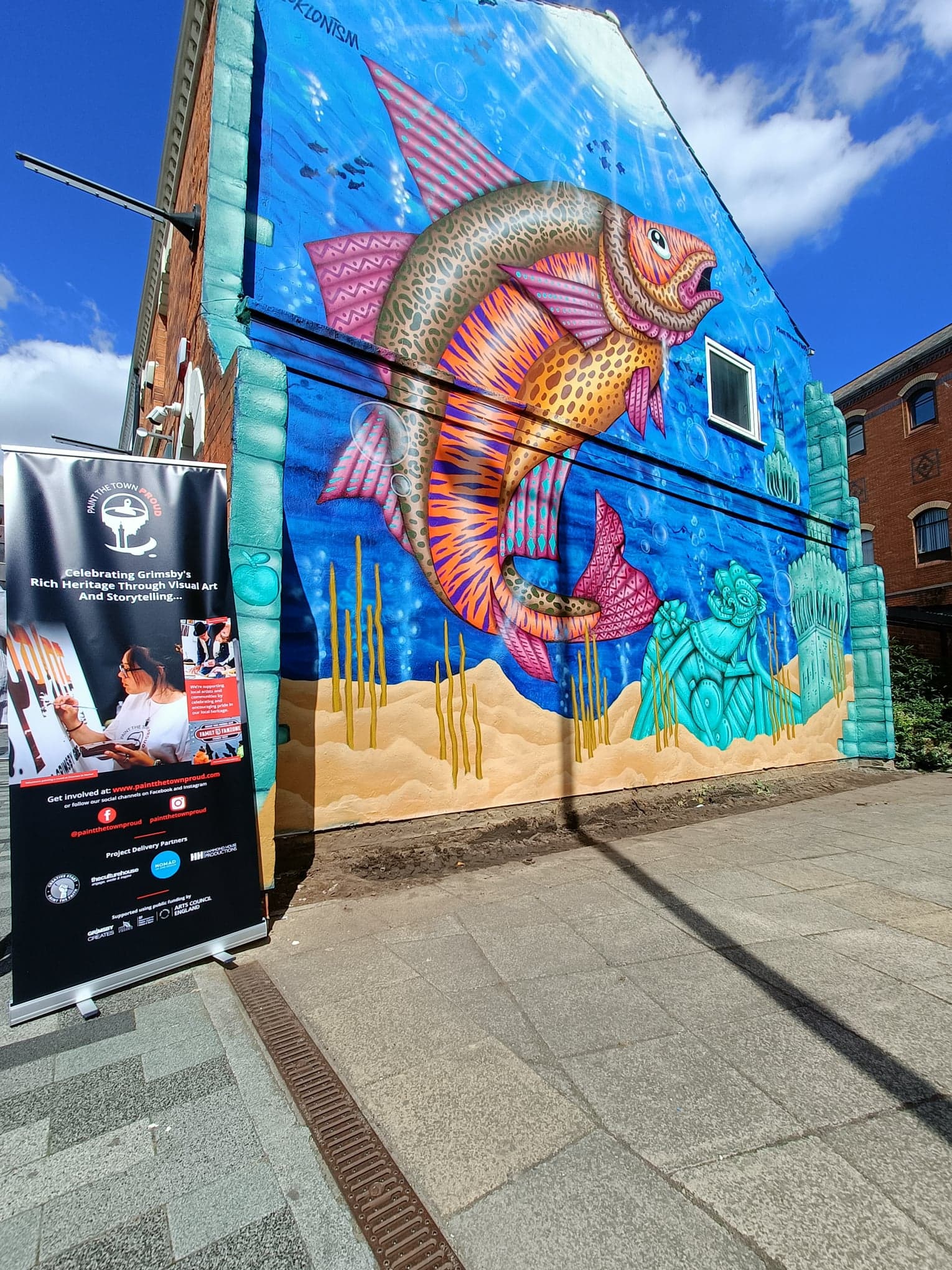 A large mural of a fish on the side of a building