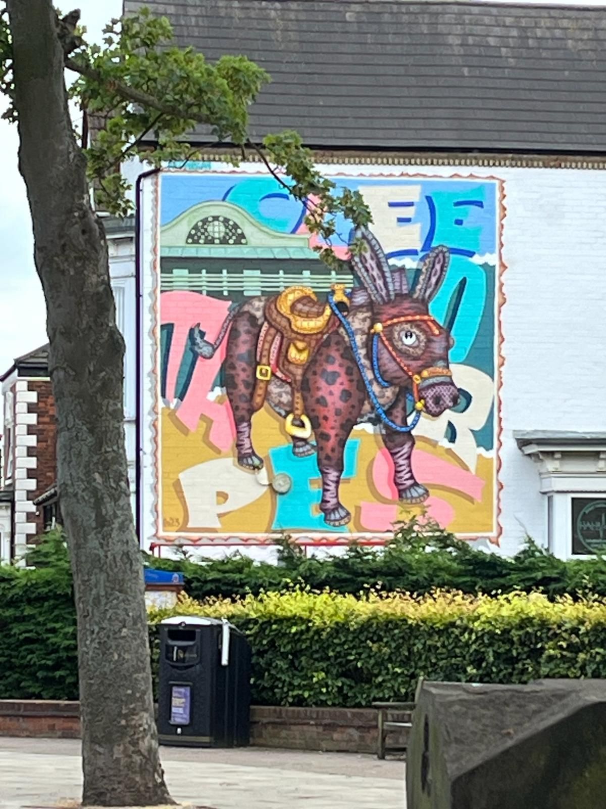 A painting of a donkey on the side of a building