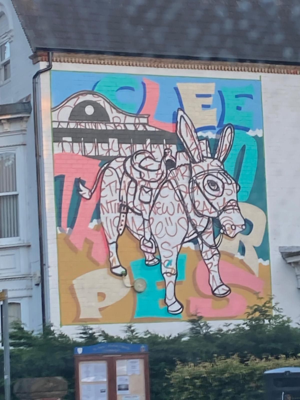 A painting of a donkey on the side of a building