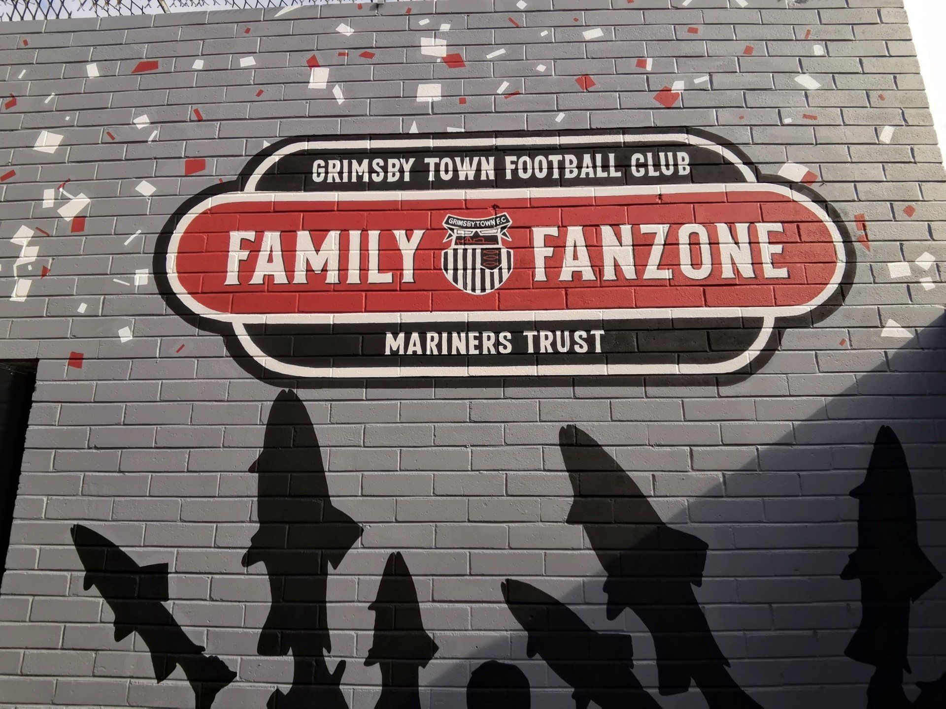 A sign on a brick wall that says family fanzone
