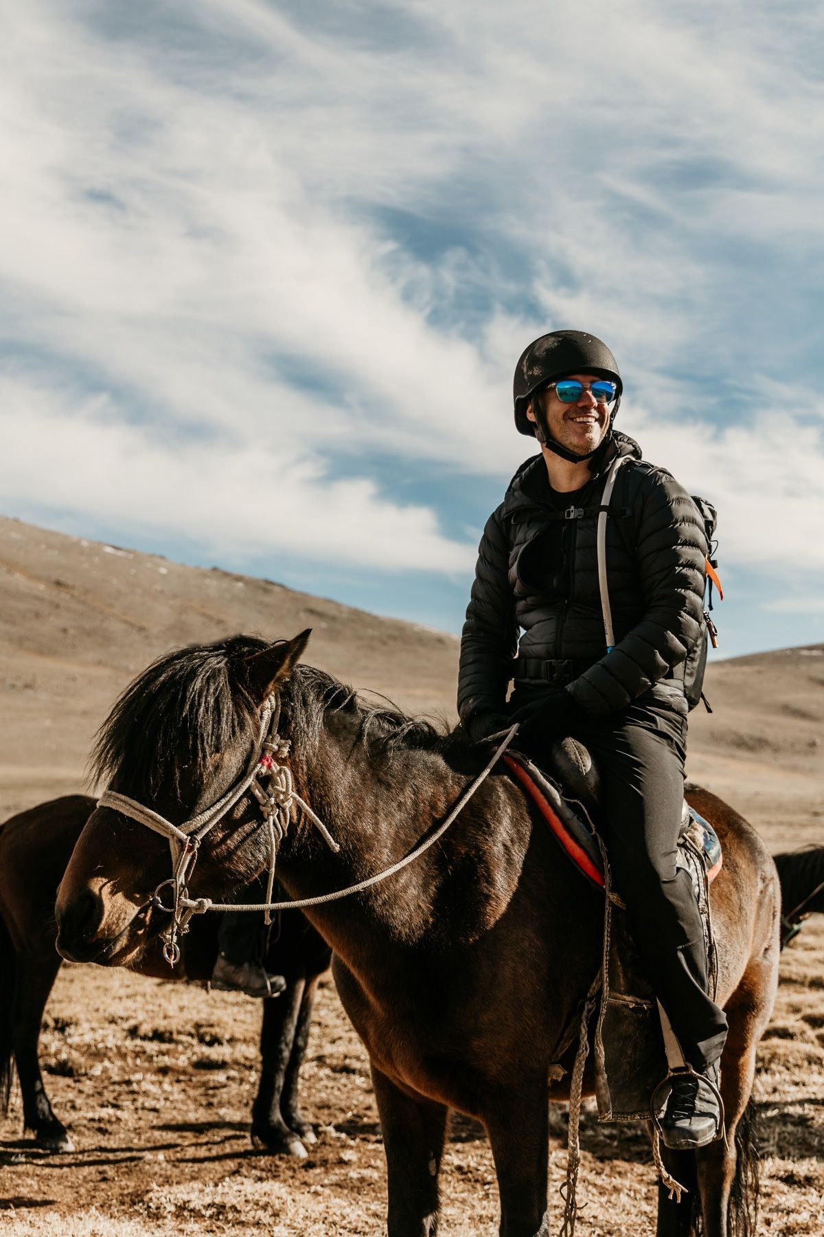 A man is riding a horse in a field.