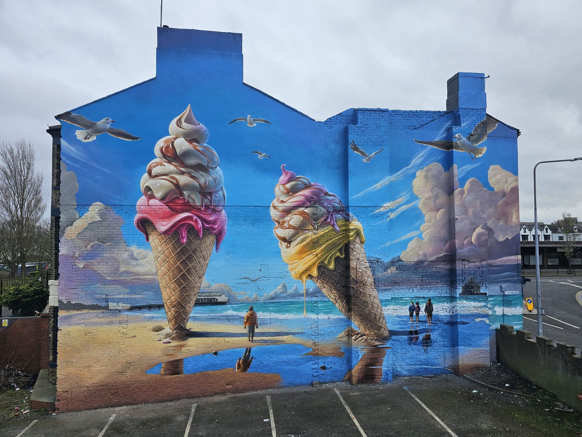 A large mural of two ice cream cones on the side of a building.