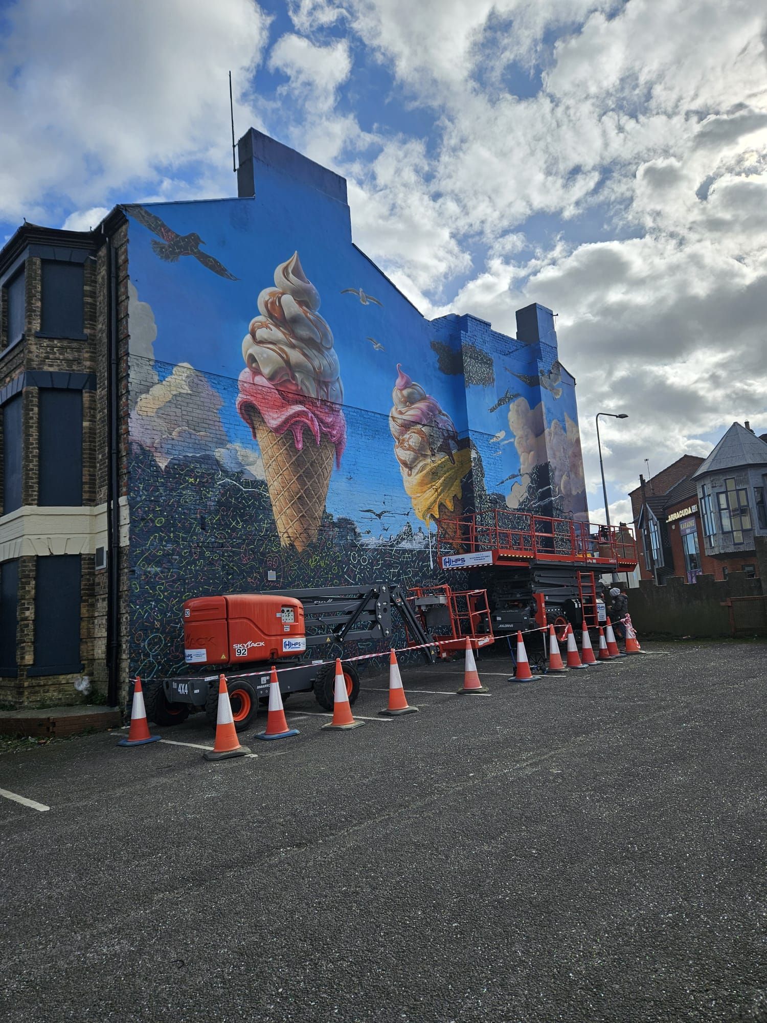 A large mural of ice cream cones on the side of a building
