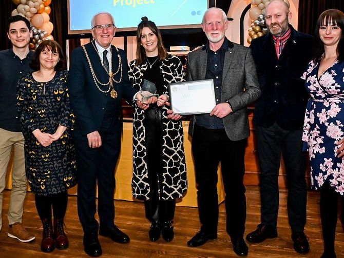A group of people standing next to each other holding a certificate.