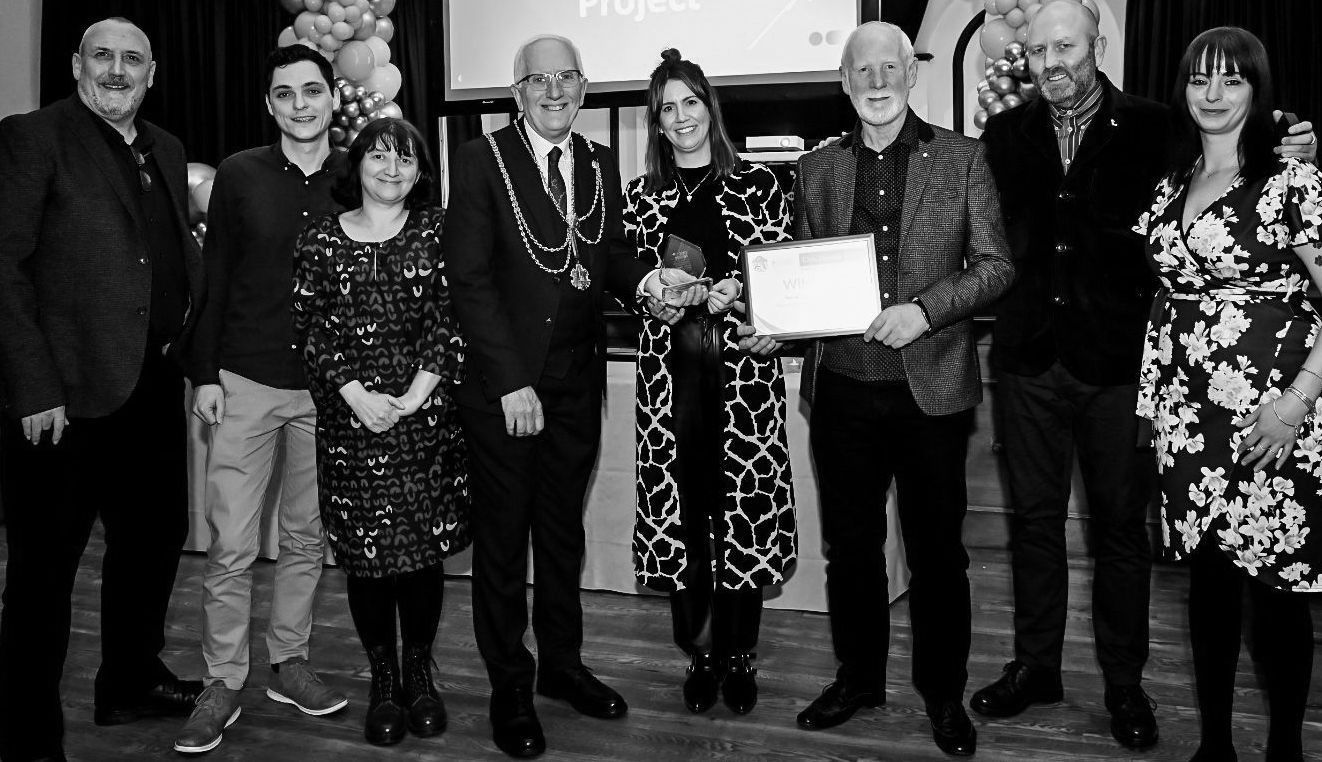A group of people are standing next to each other in a black and white photo.