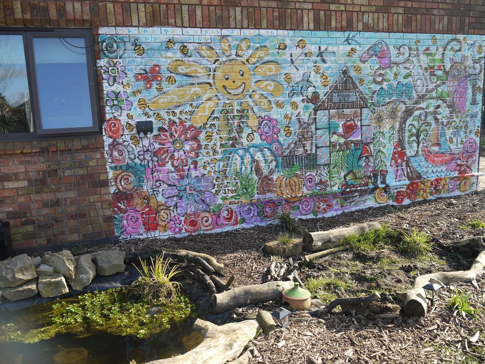 A brick wall with a colorful mural on it