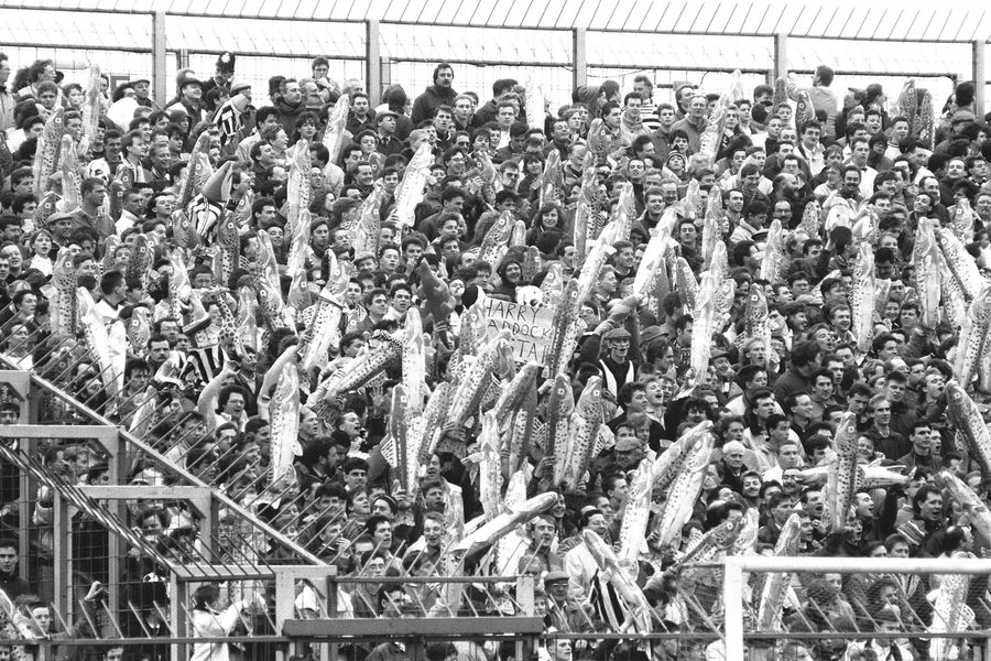 A black and white photo of a crowd of people in a stadium.
