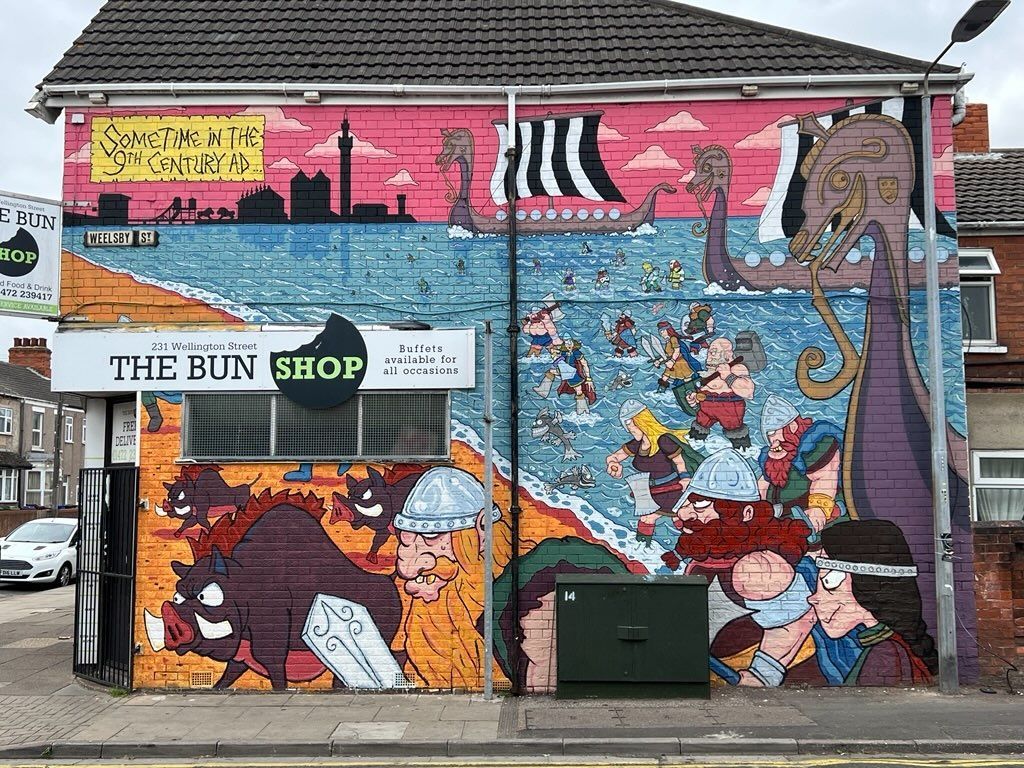 A colorful mural on a building, labeled