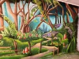 A painting of a forest with trees and flowers on a wall.