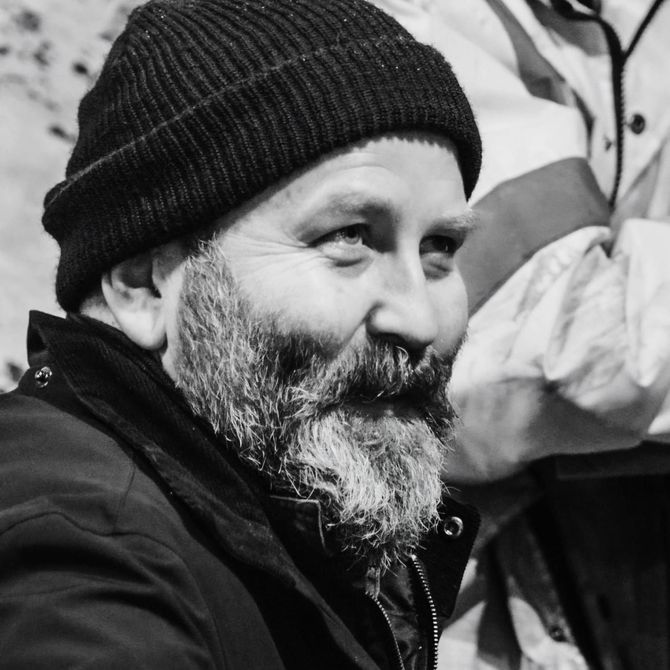 A man with a beard wearing a black beanie
