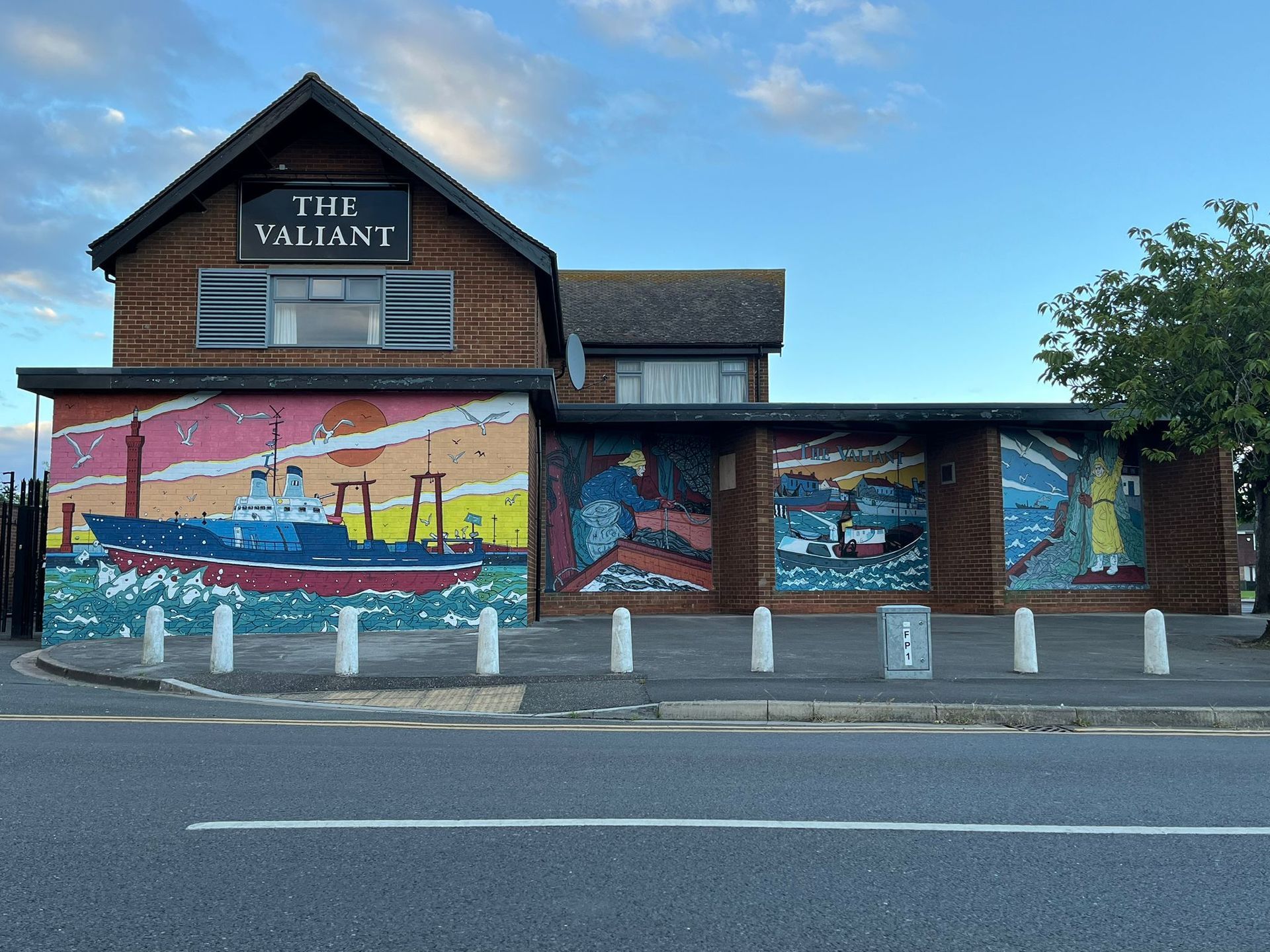 A large mural on the side of a building that says the valiant
