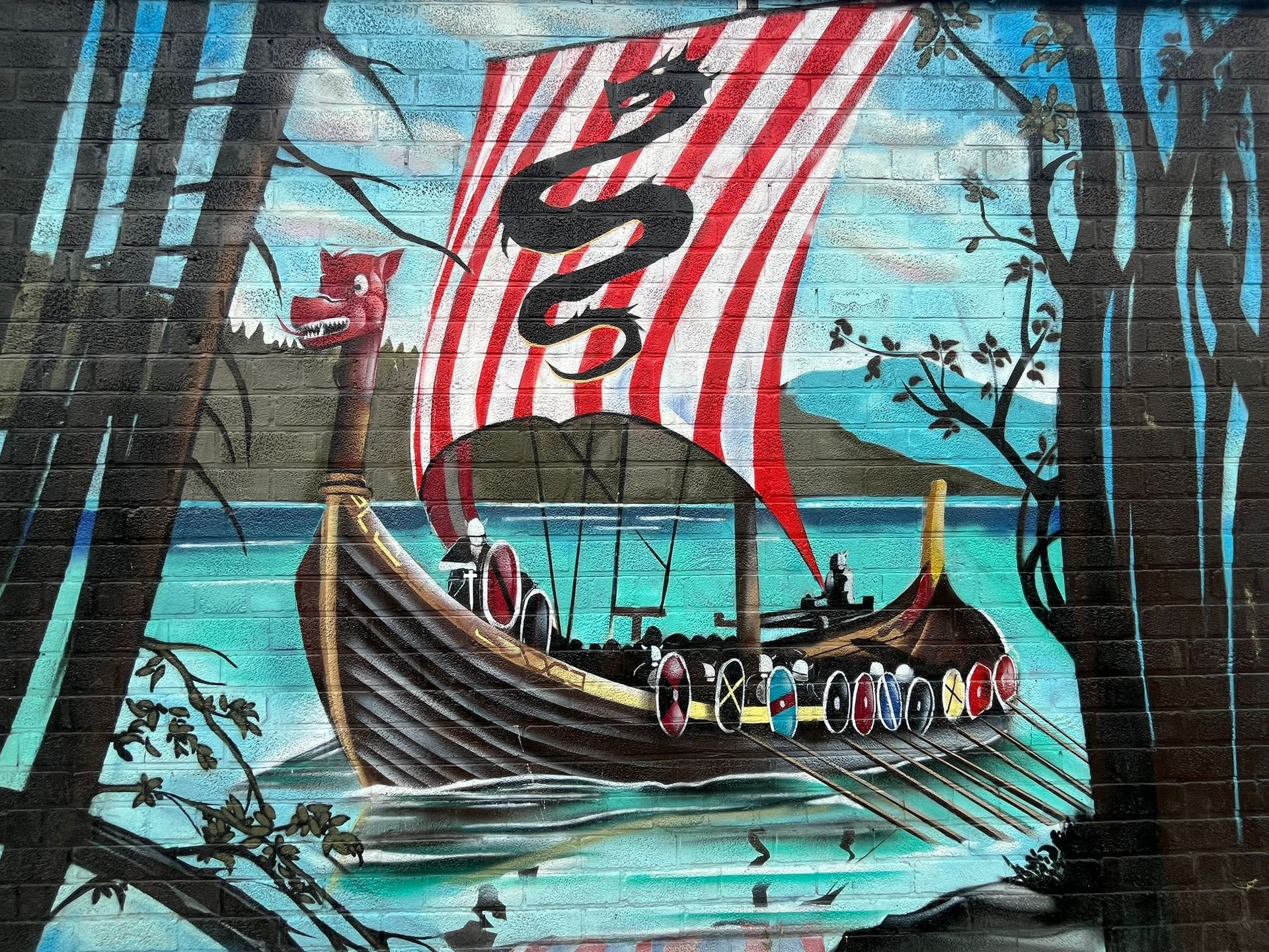 A painting of a viking ship with a snake on the sail