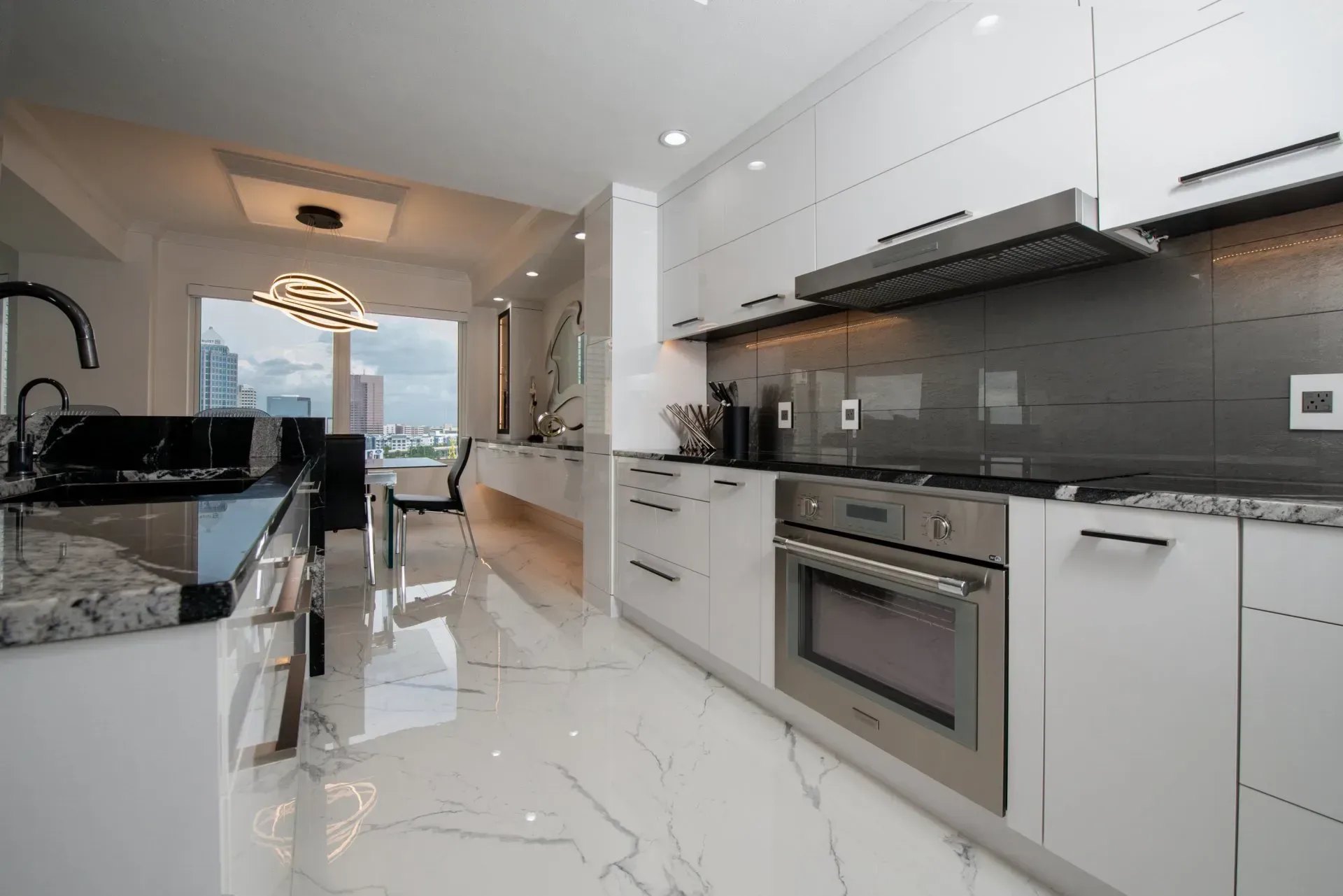 A kitchen with white cabinets and stainless steel appliances.