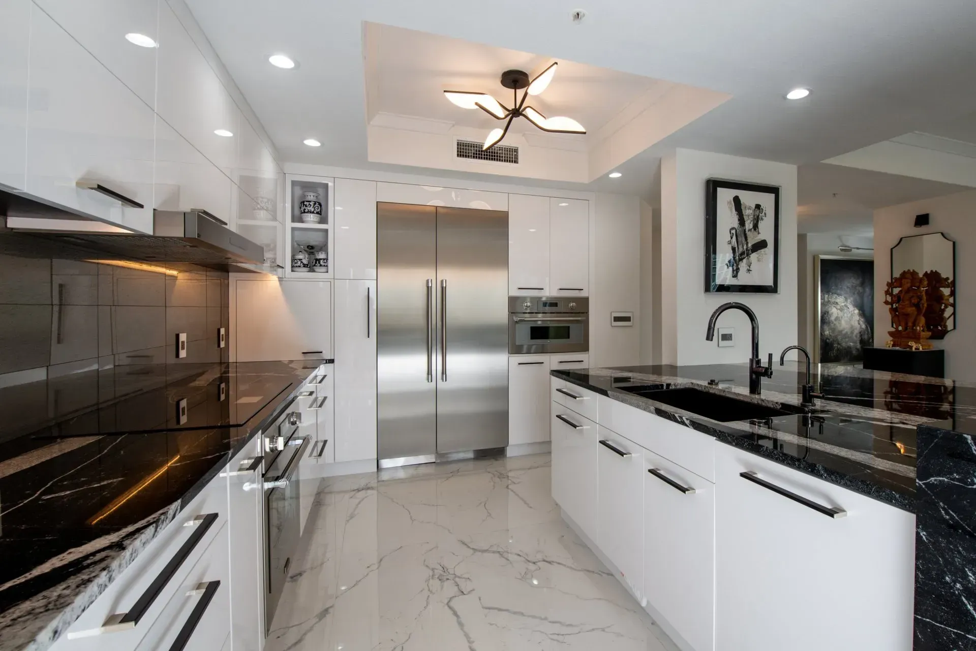 A kitchen with white cabinets and stainless steel appliances