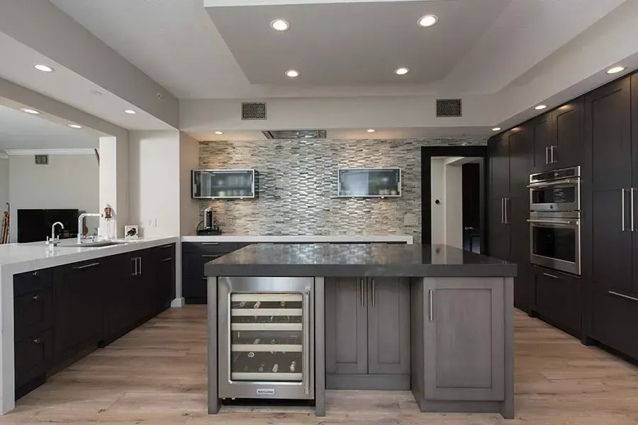 A large kitchen with a large island and a wine cooler.