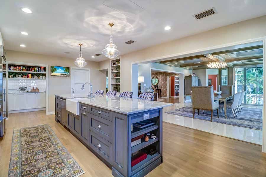A large kitchen with a large island and a sink.