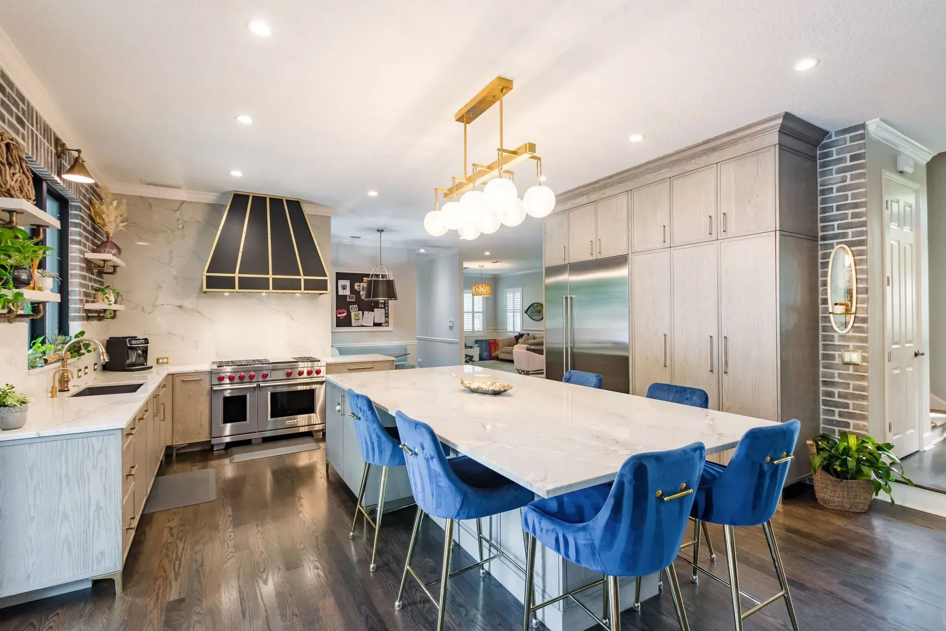 A large kitchen with a long table and blue chairs.