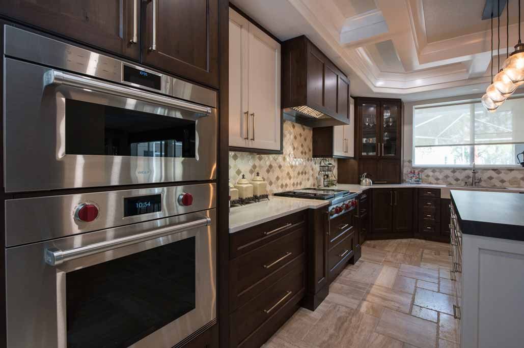 A kitchen with stainless steel appliances and wooden cabinets.