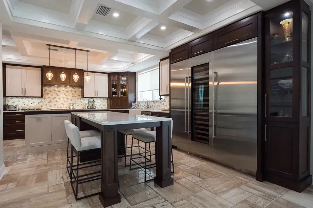 A kitchen with stainless steel appliances and a large island.