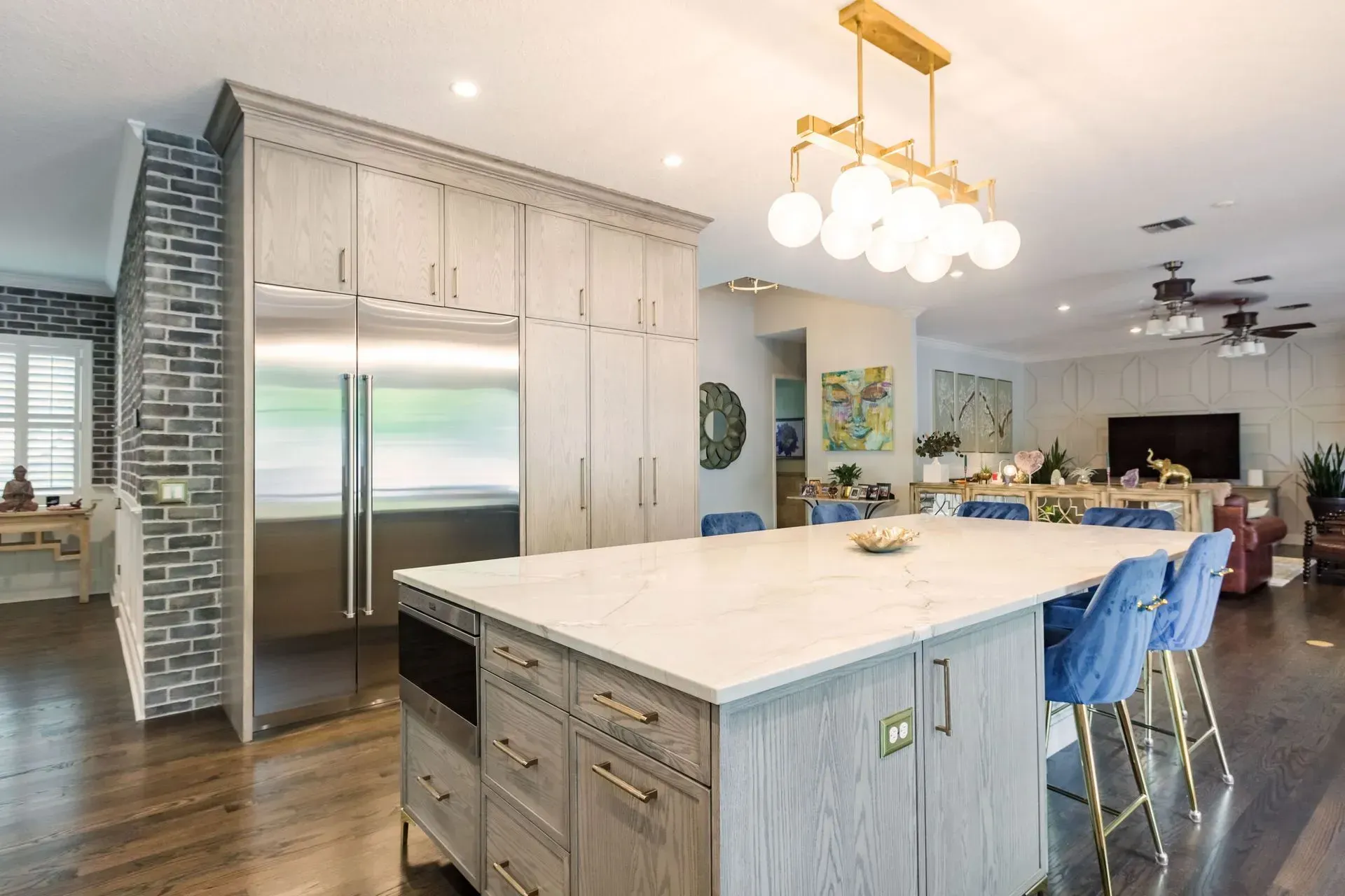 A kitchen with a large island and stainless steel appliances.