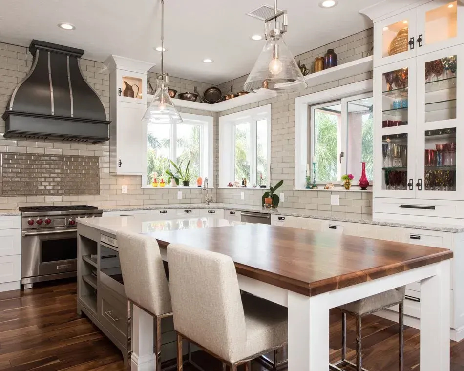 A kitchen with a table and chairs and a stove.