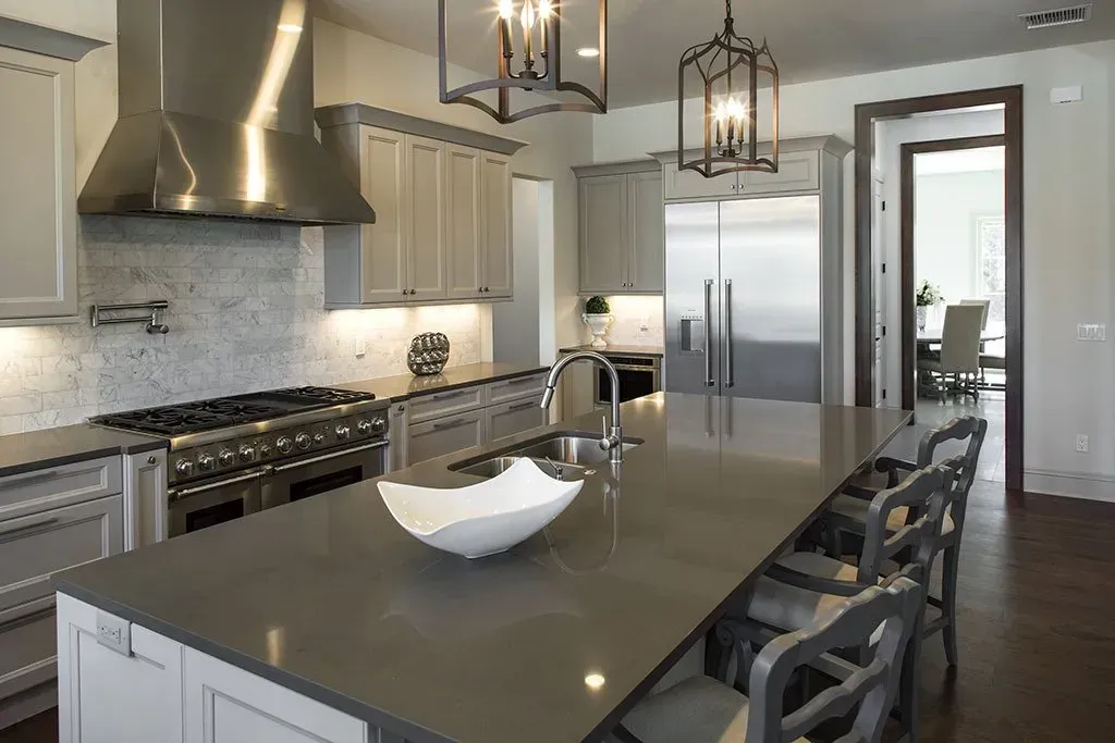 There is a large island in the middle of the kitchen.
