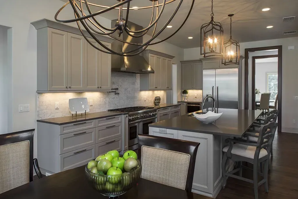 There is a bowl of apples on the table in the kitchen.