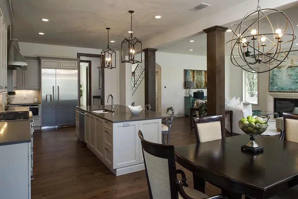 A kitchen and dining room with a chandelier hanging from the ceiling
