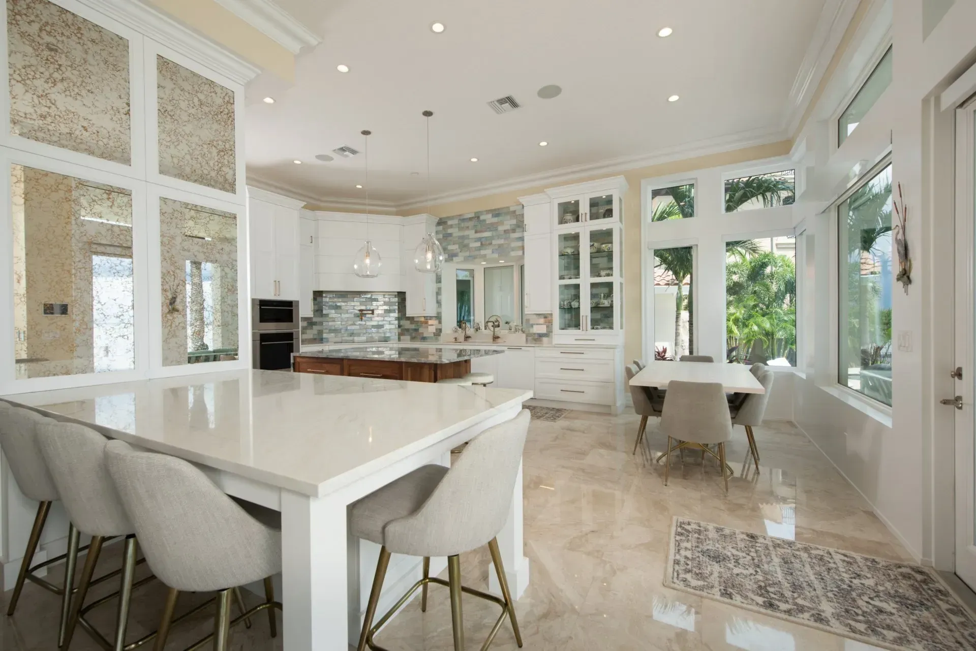 A large kitchen with a table and chairs in it.