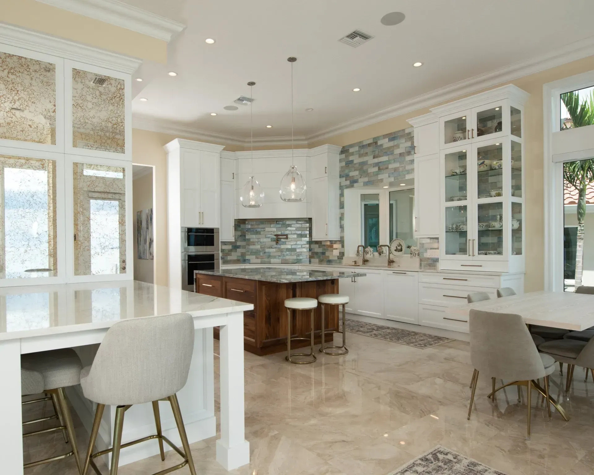 A kitchen with white cabinets and a large island