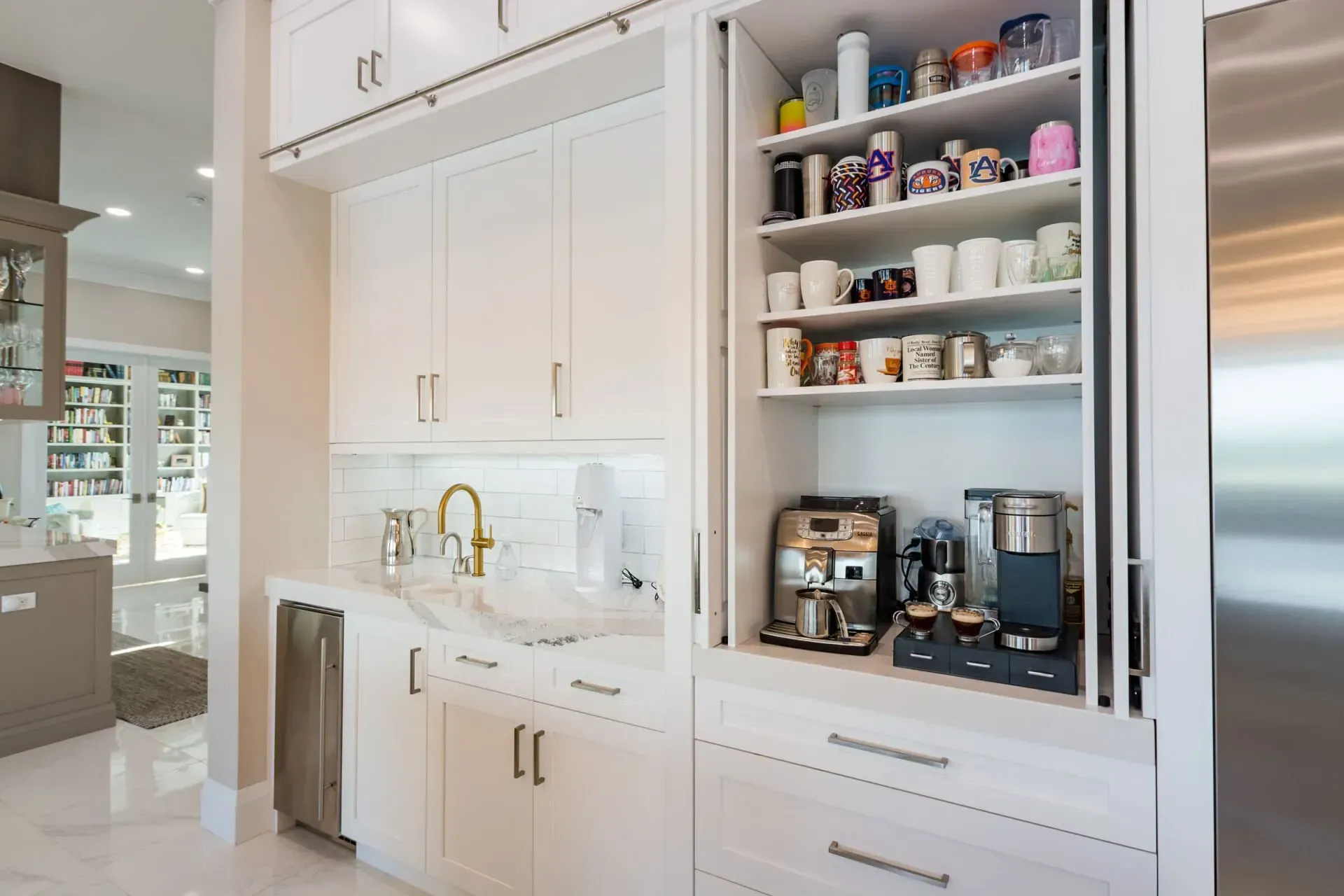 A kitchen with white cabinets and stainless steel appliances.