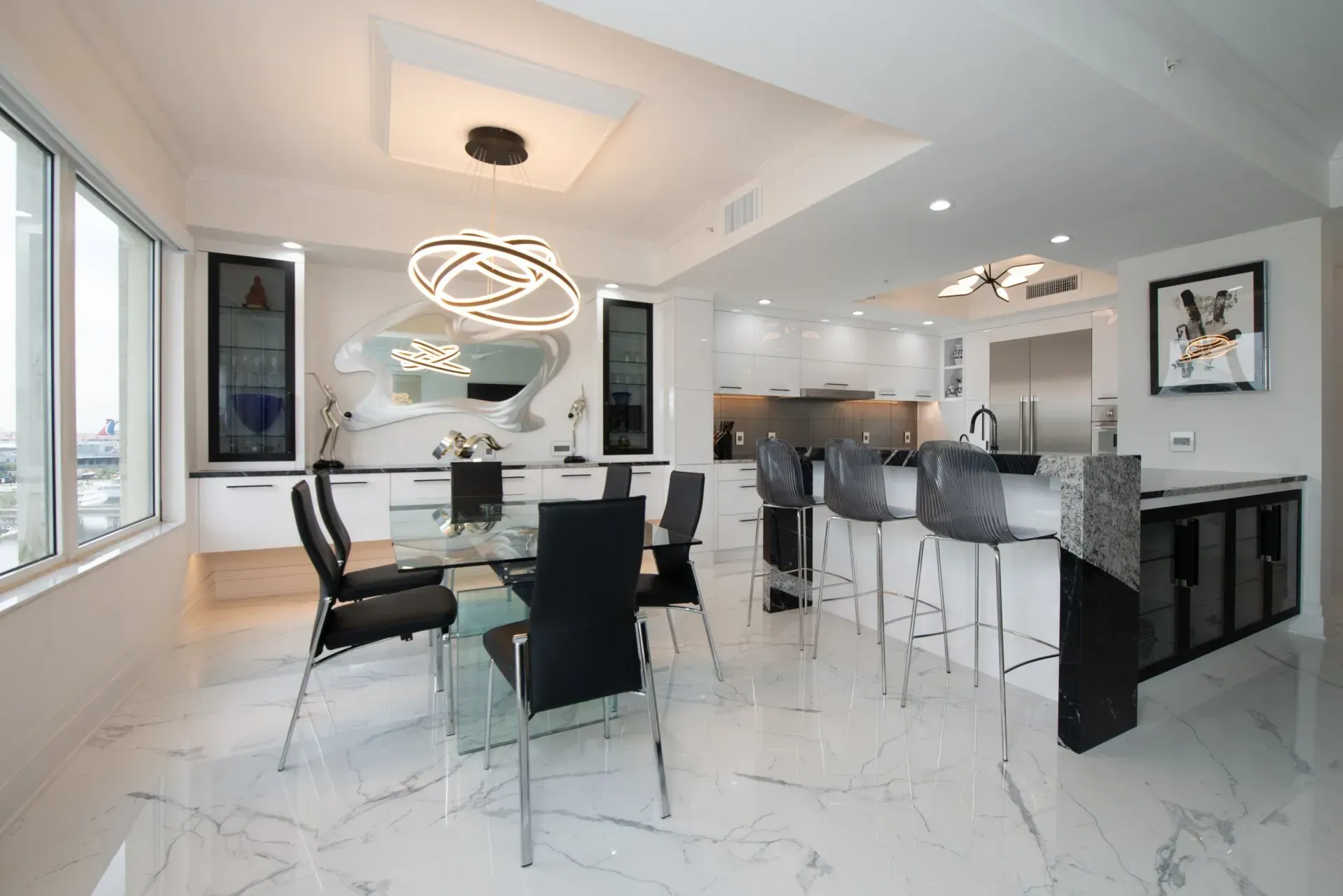 There is a dining table and chairs in the middle of the room.
