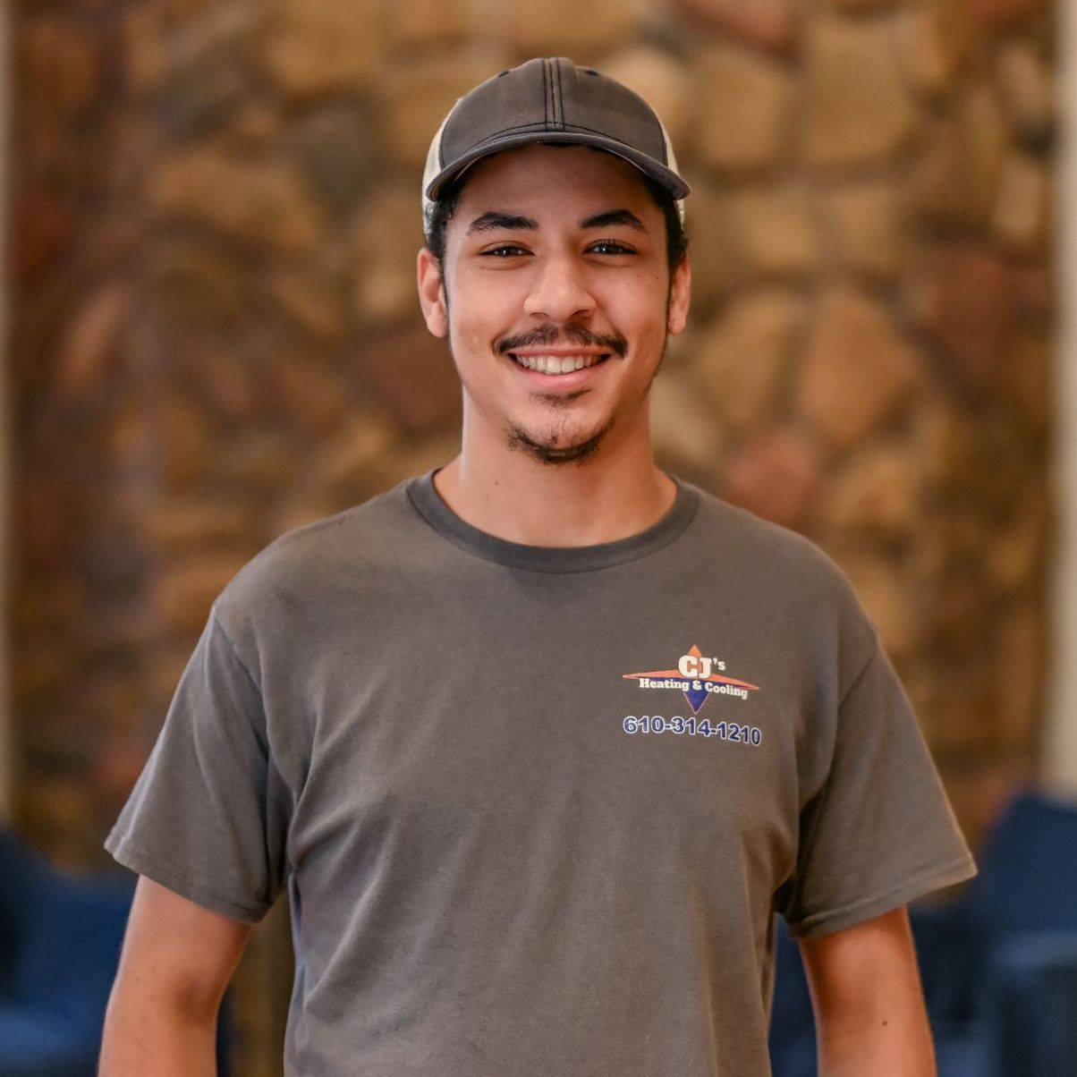 A man wearing a hat and a t-shirt that says ' ec ' on it