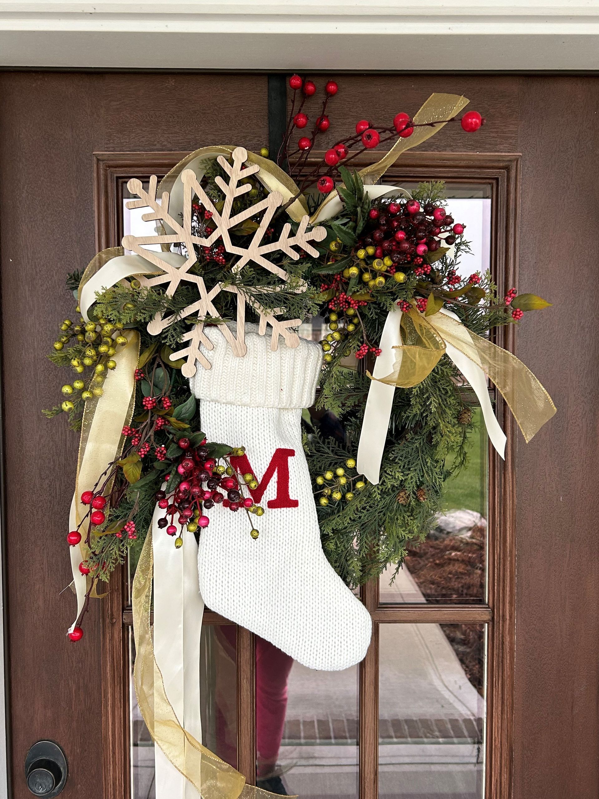 A Christmas Stocking with the Letter M on it is Hanging on a Door — Jasper, IN — Green Thumb Landscaping and Garden Center 