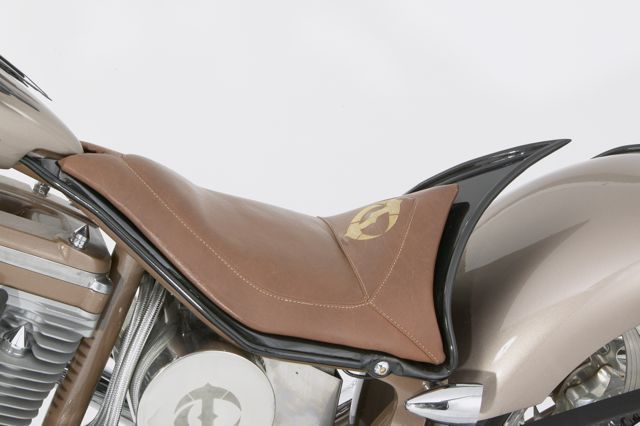 A close up of a motorcycle with a brown seat