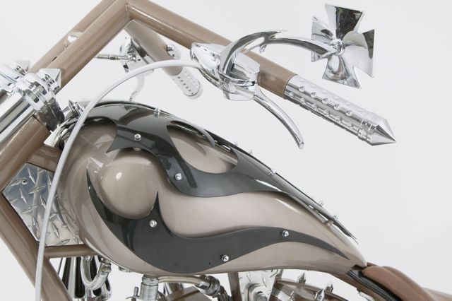 A close up of a motorcycle with a flame design on the tank